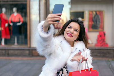 Woman photographing with mobile phone