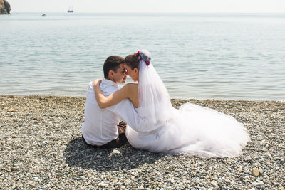 Young couple sitting on beach