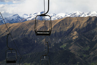 Ski lift over snowcapped mountains