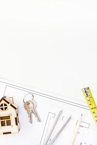 High angle view of chain hanging over white background