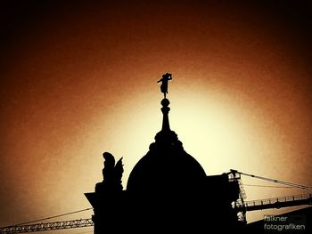 Low angle view of silhouette building against clear sky