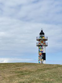 Low angle view of people walking on beach against sky