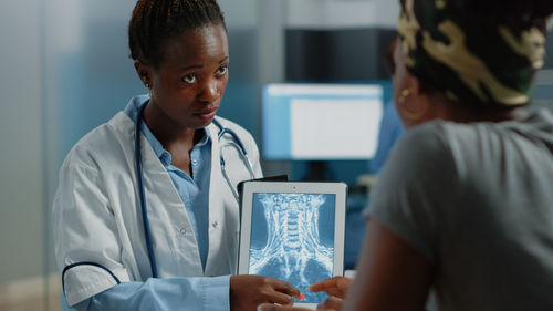 Doctor showing medical x-ray to patient