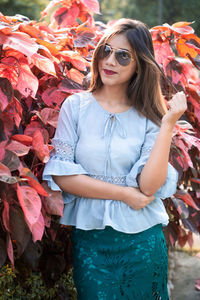 Young woman wearing sunglasses standing outdoors