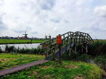 Traditional windmill on field against sky