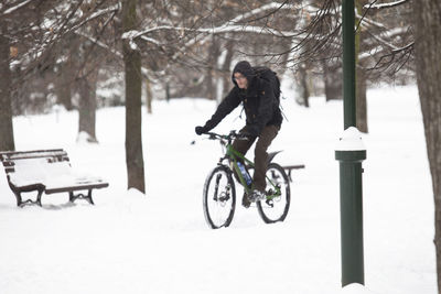 Man riding bicycle on snow