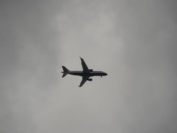 Low angle view of airplane flying in sky