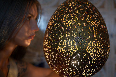 Close-up portrait of woman with illuminated lighting equipment