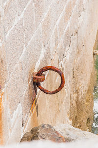 Close-up of rusty metal hanging on wall