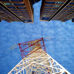 Low angle view of crane against sky