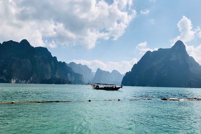 Scenic view of sea and mountains against sky