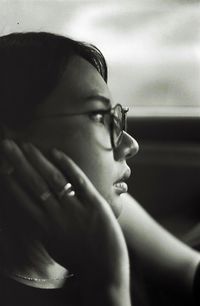 Close-up of young woman wearing eyeglasses in car