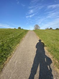 Shadow of man on road