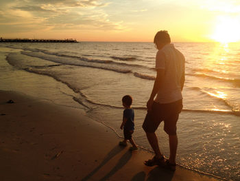 Full length of children on beach during sunset