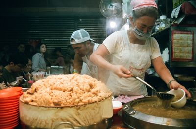 People having food at market