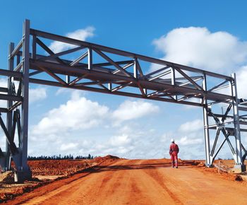 Man walking under a bridge