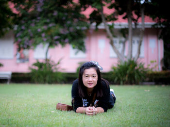 Portrait of smiling girl sitting on grass