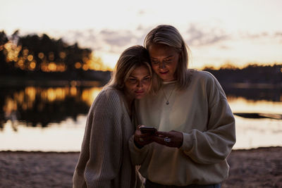 Female couple using cell phone