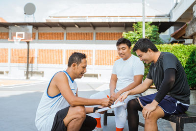 People sitting in traditional clothing