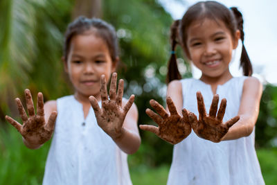 Cute friends showing dirty hands