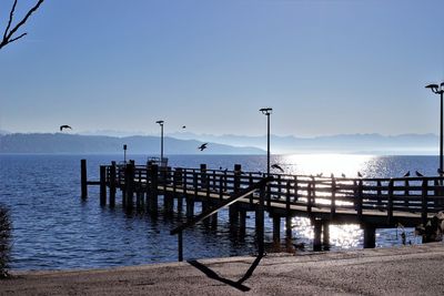 Pier over sea against clear sky