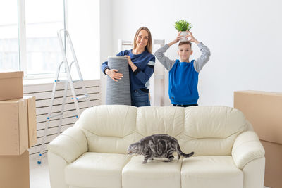 Portrait of mother and son standing at home