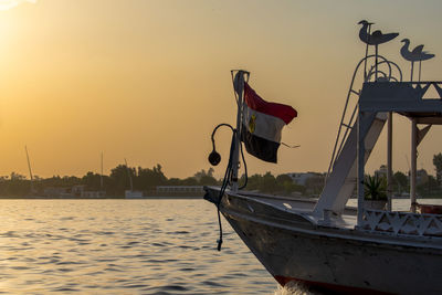 Low angle view of boat in sea against sky during sunset