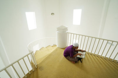 Man sitting on staircase at home