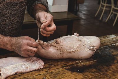 Cropped hand of man preparing food