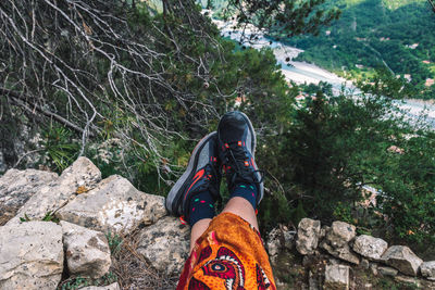 Low section of person standing on rock