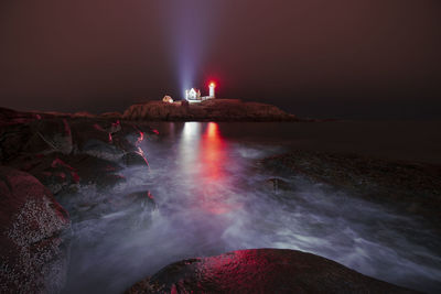 Portland head light on rugged new england coast in snow storm