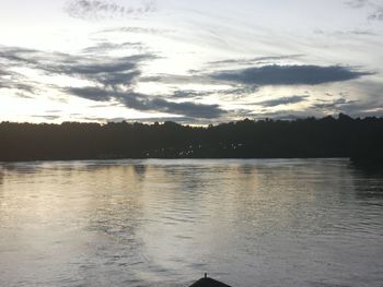 Scenic view of lake against sky at sunset