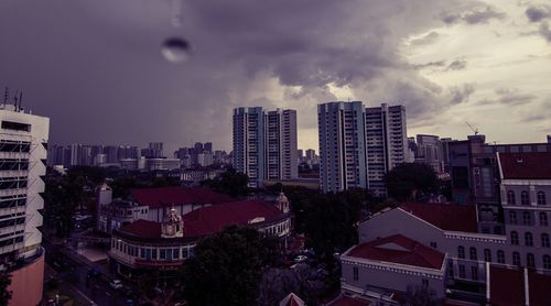 Buildings against cloudy sky