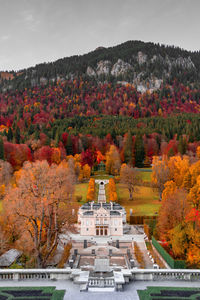 Trees and buildings against sky during autumn