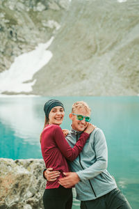 Portrait of a smiling young woman standing in lake