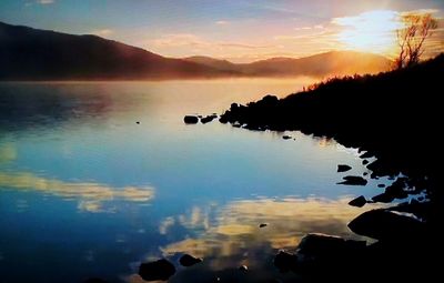 Scenic view of lake against sky during sunset