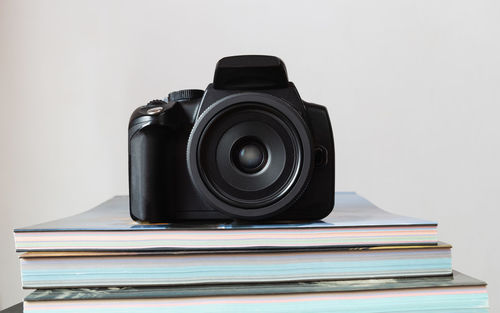 Close-up of camera on table against white background