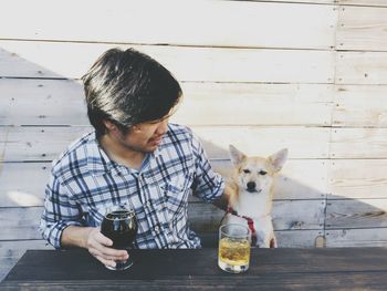 Man with dog having drinks
