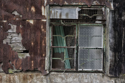 Broken window of abandoned house