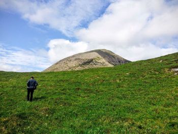 People standing on grassy field