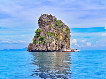 Scenic view of rock formation in sea against sky