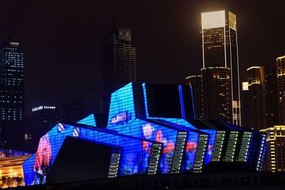 Illuminated modern buildings in city at night