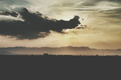 Scenic view of landscape against cloudy sky