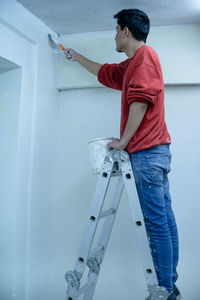 Young man painted white his new house