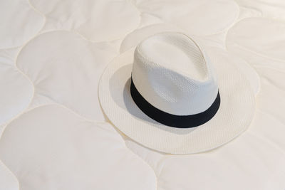 High angle view of hat on bed