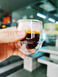 Close-up of hand holding beer glass