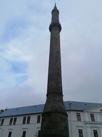 Low angle view of building against cloudy sky