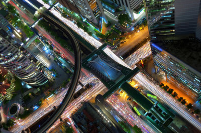 High angle view of illuminated city street and buildings at night