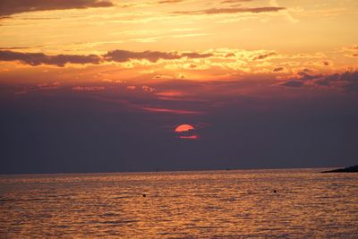 Scenic view of sea against orange sky