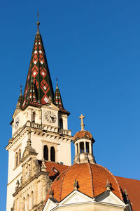 Low angle view of church against clear blue sky.